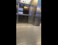 Man rides luggage scooter cart around airport 