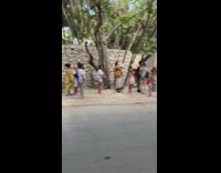 Line Forms to Takes Photos with Statue 