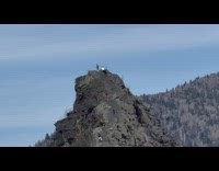 Man reached the mountain top with hands up