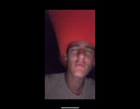 Guy wears giant red hat and rides motorcycle