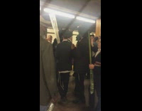 Line of Amish ben in suits conga line circle walking subway station platform