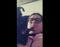 black dog paws at face of woman with glasses