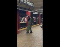 Man Plays Harmonica at Subway Station 