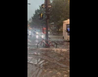 Bike locked on pole on flooded street