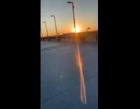 Three guys march across rooftop parking garage