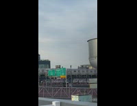 Three people subway surfing a departing train