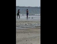 Guy squats pretends to use battle rope 