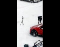 Woman shovels snow for video at yard