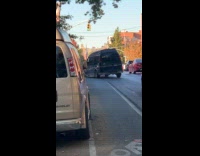 Man driving rundown van on street