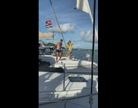 Woman bikini jacket stand yacht flag windy