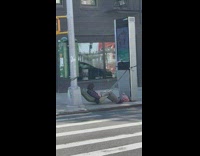 Guy lays in sidewalk hammock 