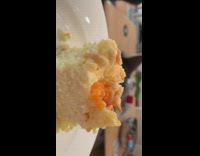 Cat touches dessert on plate licks paw 