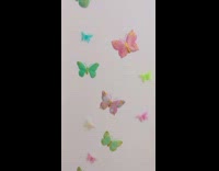 Fluffy cat wears pink wings 