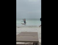 Guy lay down on beach leg split