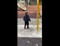 Two cousins chasing each other at playground playing