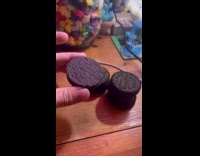Woman shows flipped Oreo cookie from package