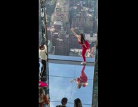 Woman in red outfit legs upwards near the glass