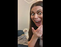 Girl laughs at dog with bulging big eyes filter
