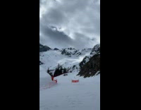 Snow mobile drifts and roll on the corner of the snowy mountain