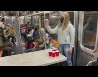 Two Girls Play Cup Pong on Subway 