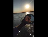 Couple hand held mirror ocean water sunset