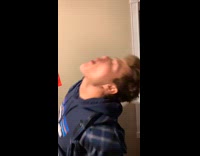 Guy spits white ball into red cup 