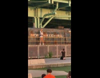 Woman raise both arms near and old train for pictorial
