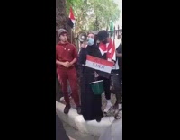 Girl yells into megaphone about yemen crisis