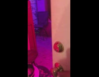 Man in afro red sweatshirt dances to rap music in garage door