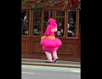 Pink flamingo costume guy walks by restaurant 