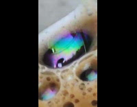 Trippy colors swirl inside coffee bubble mug