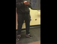 Guy listens to music out loud on train when he has  earphones in his pocket