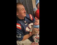 Guy holding small baby apologizing 