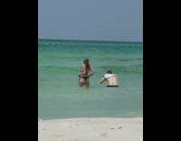 Girl black bikini hold panty strap beach