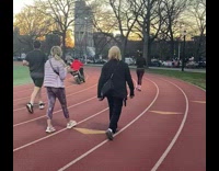 Guy rides scooter around track at park