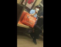 Blue shirt guy sprays cologne perfume subway