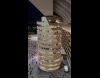 People walk down spiral walkway after event