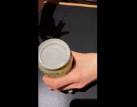 Woman shows slice of lemon inside asahi can