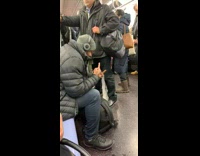 Guy flips off his weed while rolling a blunt on subway train