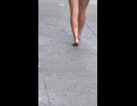 Woman barefoot walking on street