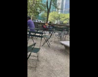 Guy holds pigeon bird lady photographs phone 