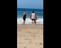 Woman does product photoshoot at the beach