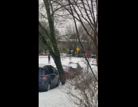 Woman remove jacket hang pole street snow
