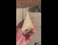 Man throws chips on the wall along the street 