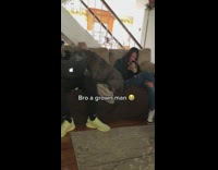 Big Dog Sits Beside Man on Couch