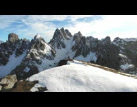 Guy lifts girl handstand mountain snow drone