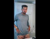 Guy wearing grey shirt dances and moves hips