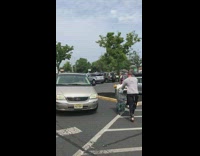 guy coming out of grocery store with black wet suit