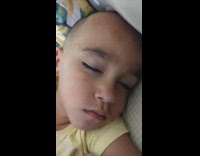 Baby asleep with his eye slightly open