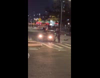 Police officer helping man inside crashed car 